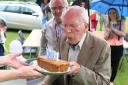 Spitfire pilot John Beresford blows out the candles as he celebrates his 100th birthday at Ampney Crucis vilage fete