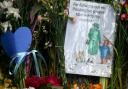 Flowers plus the Paddington image placed in memory of the Queen outside Highgrove House