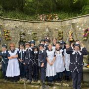 Pupils from Bisley Blue Coat Church of England Primary School dressed up at the village wells with flowers to celebrate Ascension Day