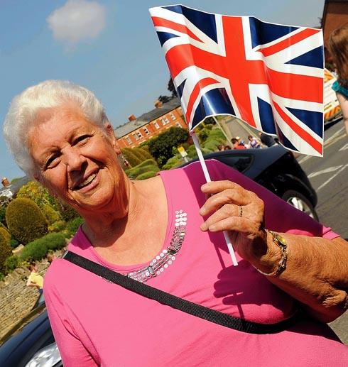 AS many as 20,000 spectators thronged the streets and cheered enthusiastically as the Olympic Torch wound its way through Stroud.