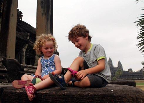Siblings Layla, two, and Finley, four, play together near the temples at Angkor Wat in Cambodia