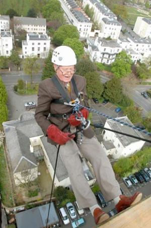 Les Stroud, 93, hanging off a building