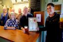 Tony Hill (right, chair of Stroud CAMRA) presents the certificate to Rob and Ali Brady from Chalford Sports & Social Club with Stroud CAMRA members