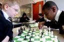 Josh Haulbrook and Tyrone King play with one of the new chess sets at Tong High School, 2008s sets, 2008