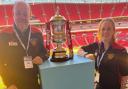 Dursley town ladies coaches Neil Sharp and Stephanie Hill posing with the FA Cup trophy at Wembley stadium