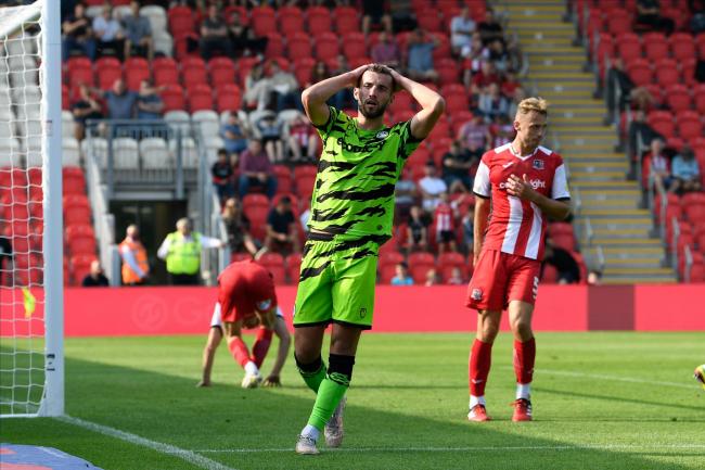 Baily Cargill (6) of Forest Green Rovers hold his head after missing a goal scoring chance during the EFL Sky Bet League 2 match between Exeter City and Forest Green Rovers at St James' Park, Exeter, England on 4 September 2021..