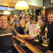 Stroud CAMRA members celebrate the launch of the Good Beer Guide 2023 at the Ship Inn, Brimscombe. (Front left, Tony Hill, chair of Stroud CAMRA, front right,  Wes Birch, licensee of the Ship). Photo by Bill Hicks. 