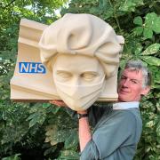 Rory Young with the model of a doctor wearing a mask which he auctioned for the NHS after his diagnosis