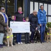 Beaudesert Park School cheque presentation 

(L-R) - Sheila Murray and guide dog Lexi, Beaudesert Park pupil Arabella, fair organiser Zahra Lucas, pupil Alexander, puppy trainer Lynsey Willis and puppy Zamba, and Miles Northwood and guide dog Nushka