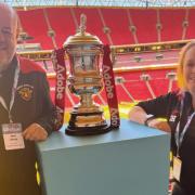 Dursley town ladies coaches Neil Sharp and Stephanie Hill posing with the FA Cup trophy at Wembley stadium