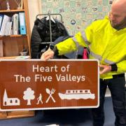 Sam Moppett the Green Spaces Team Horticulture Ranger, with one of the new signs