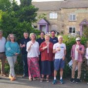 Chalford Hill Community Benefit Society committee members take a moment to celebrate with neighbours