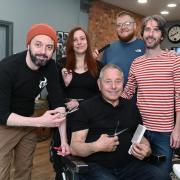29 April 2024Copyright Photographer Simon Pizzey Tim (centre)  and some of his present team Left to Right; Shane Skidmore, Katie Workman, Ashley Walker,Paul Baxter,Tim Sysum Barbers  on Gloucester Street, Stroud, Celebrates 50 Years of