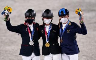 Germany's Julia Krajewski (centre) poses with her gold medal after winning the Eventing Jumping Individual Final alongside second placed Great Britain's Tom McEwen with his silver medal.